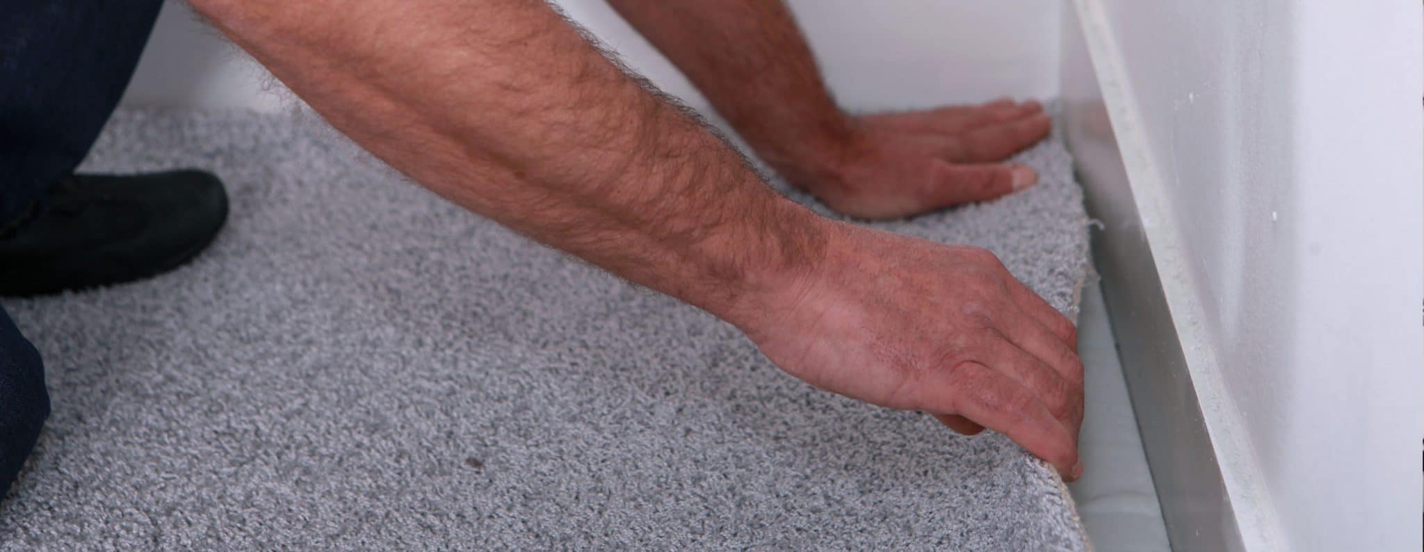 Man installing carpet