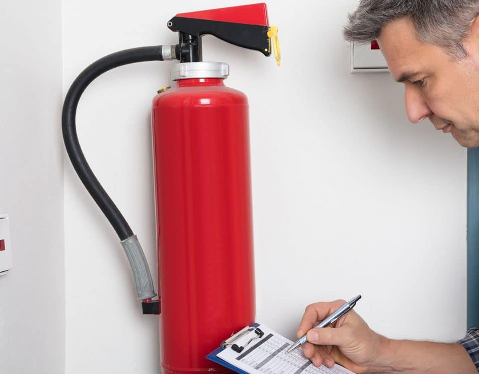 Man inspecting a fire extinguisher