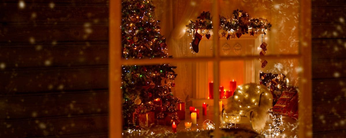 View into home with christmas tree candles and lights