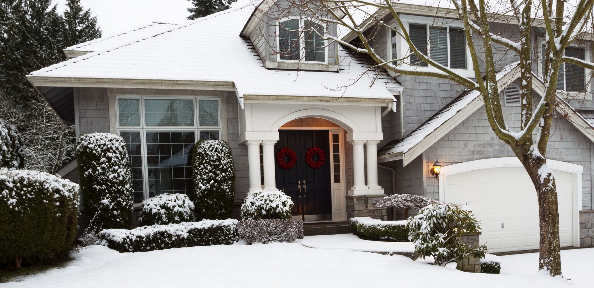 Photo of front yard of home during the holidays with fresh snow fallen that morning