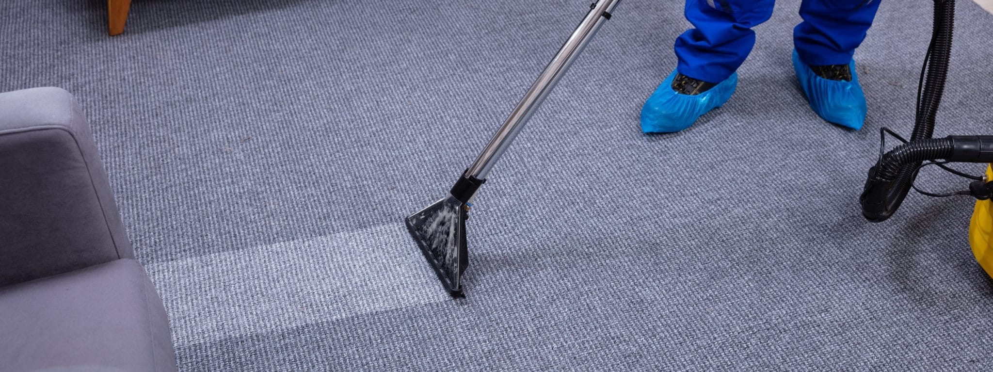 Man with carpet cleaner cleaning carpet