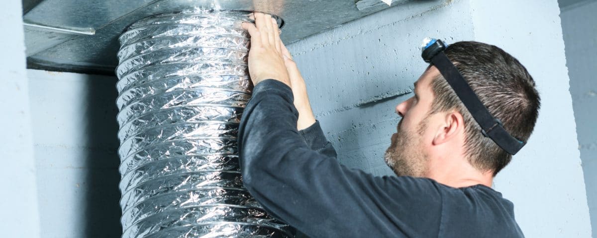 Man checking a ventilation duct