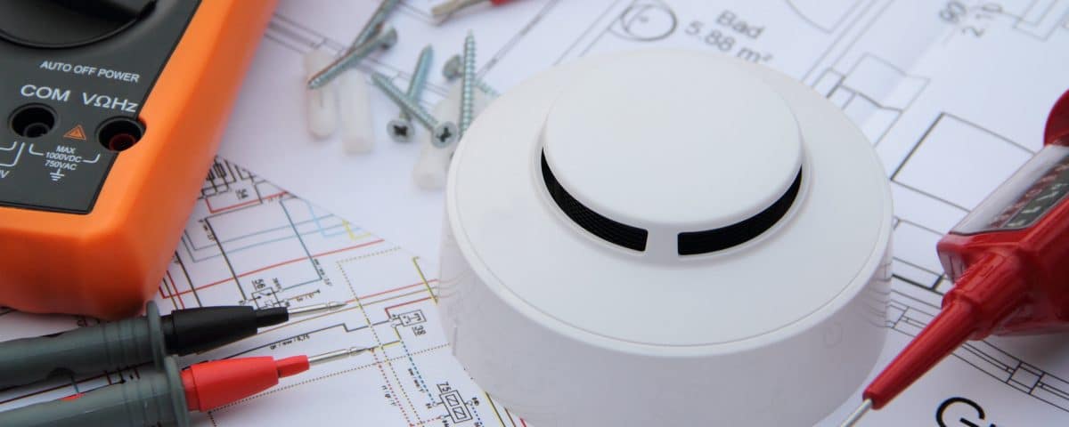 Smoke detector with wiring diagram and multimeter
