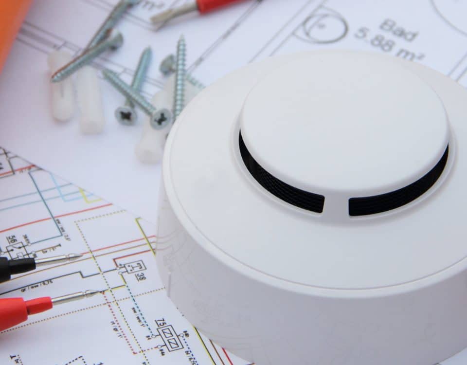 Smoke detector with wiring diagram and multimeter