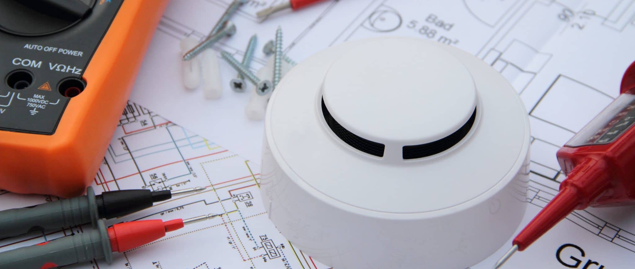 Smoke detector with wiring diagram and multimeter