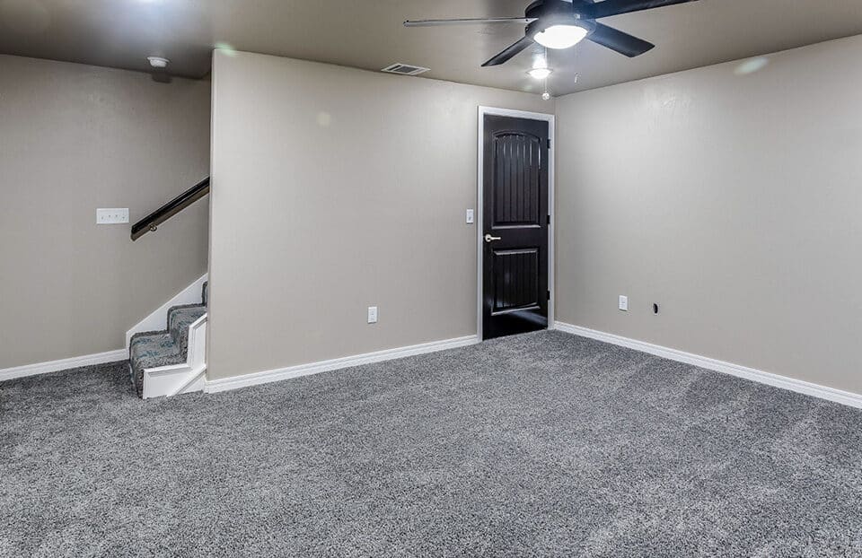 Empty basement room with brand new carpet