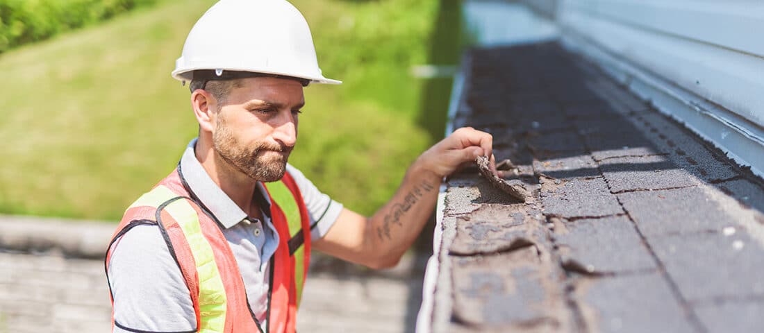 Worker inspecting the roofing of a home