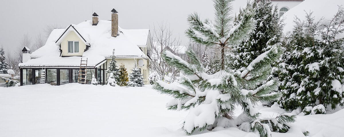 Front of a home with fallen snow in the yard