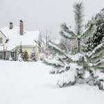 Front of a home with fallen snow in the yard