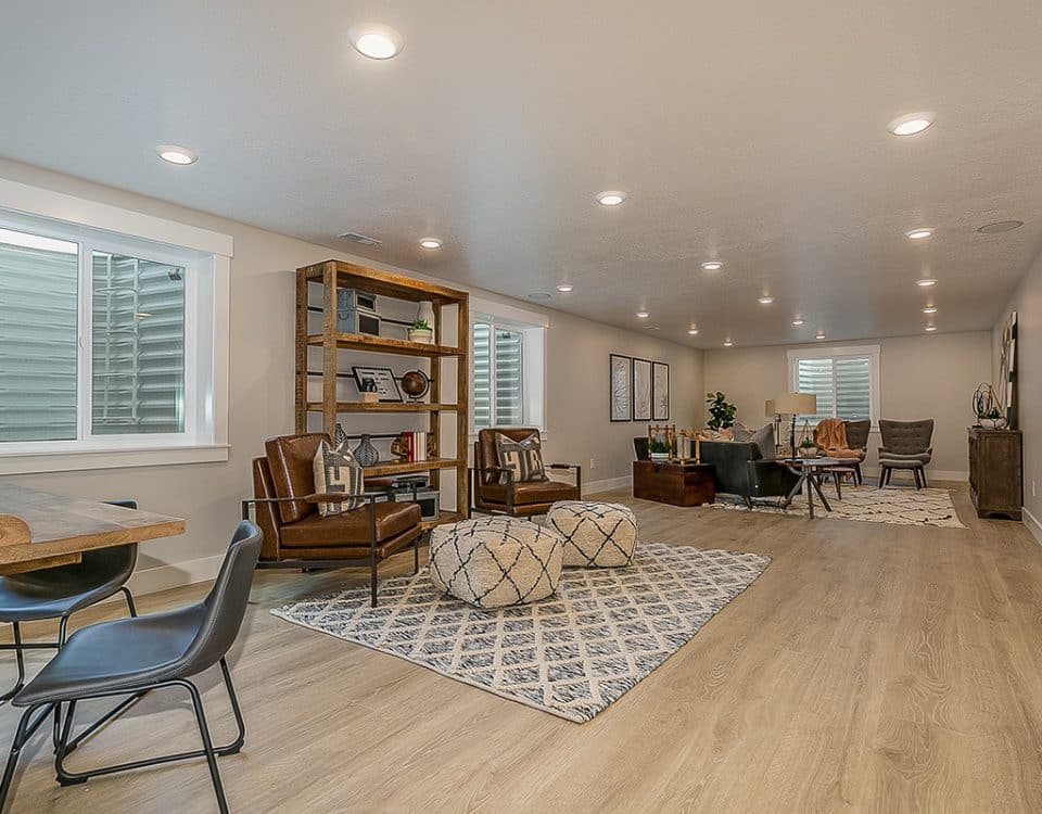 Basement of a home with table, shelves and seating