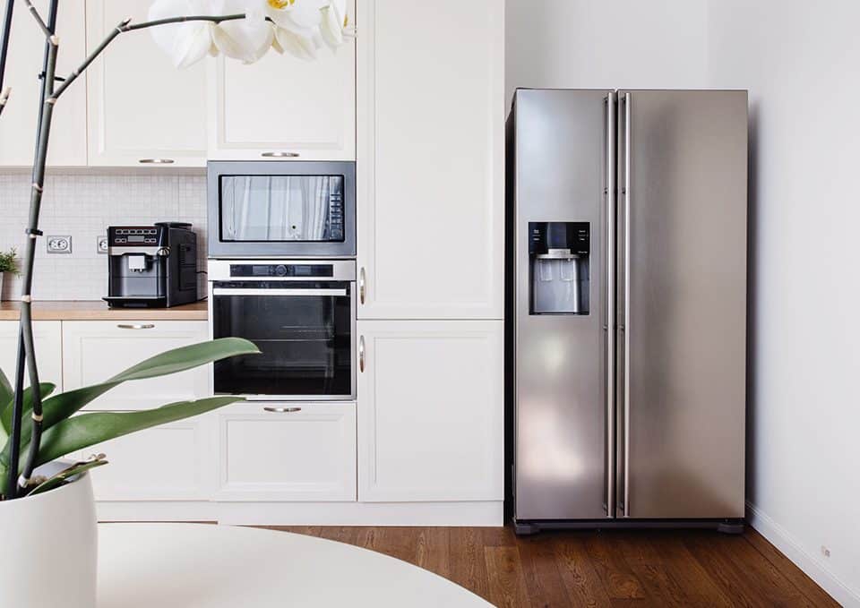 Kitchen with refrigerator, table and counter tops